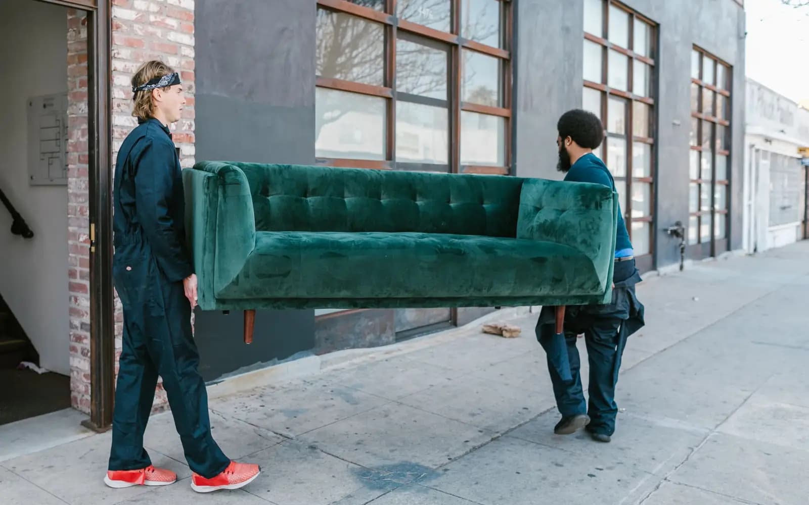 Two movers carrying a sofa